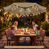 9 FT tan scalloped solar patio umbrella with 24 LED lights, providing shade and illumination for outdoor dining.