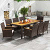 9-piece outdoor dining set featuring an acacia wood table top and brown PE rattan chairs with cushions for comfort.
