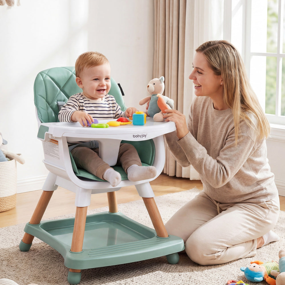 9-in-1 convertible high chair in green with soft cushion, featuring a double tray for eating and playing. Ideal for.