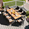 9-piece rattan dining set featuring an acacia wood table and stackable cushioned chairs, perfect for outdoor gatherings.