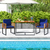 Acacia wood outdoor dining table with navy chairs, showcasing rustic style and sturdy metal frame for patio gatherings.