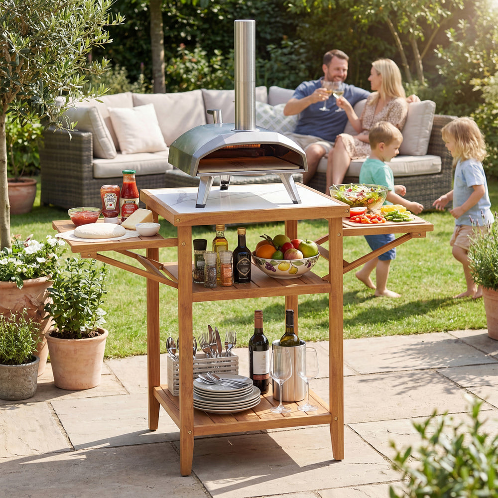 Acacia wood outdoor grill table with faux marble top, featuring drop-leaf side panels for extra prep space in the.