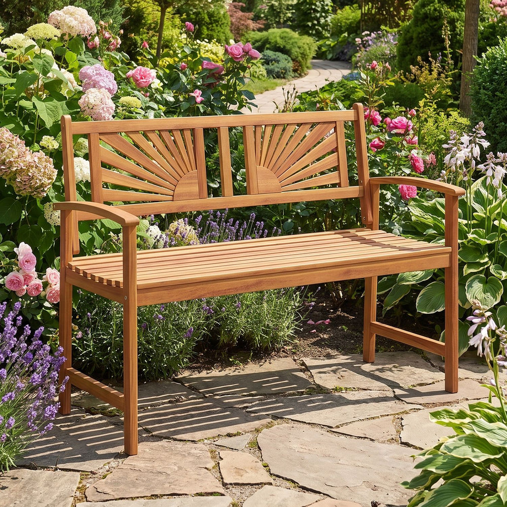 Acacia wood outdoor garden bench with sunburst back and curved armrests, perfect for two-person relaxation in outdoor spaces.