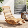 Acacia wood rocking patio lounge chair features a slatted design and ergonomic shape for optimal comfort and relaxation.