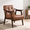 Accent chair with inclined backrest in walnut finish, featuring faux leather and soft cushion for comfortable living room seating.