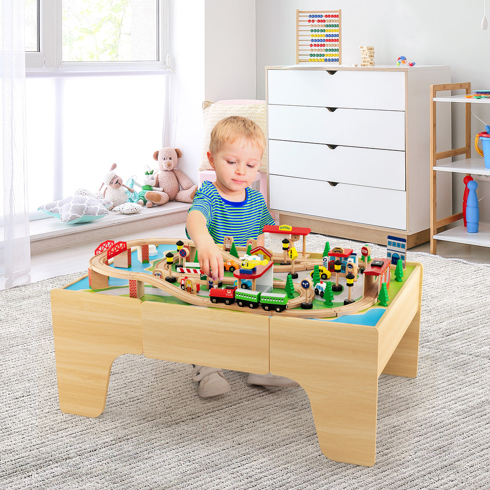 Wooden train set with 84 pieces on a reversible tabletop, designed for kids' play and creativity in a safe environment.