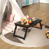 Adjustable bamboo laptop desk with tilting top and drawer, perfect for study or living room use.
