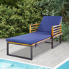 Adjustable cushioned patio chaise lounge chair in navy with a sturdy acacia wood frame, ideal for poolside relaxation.