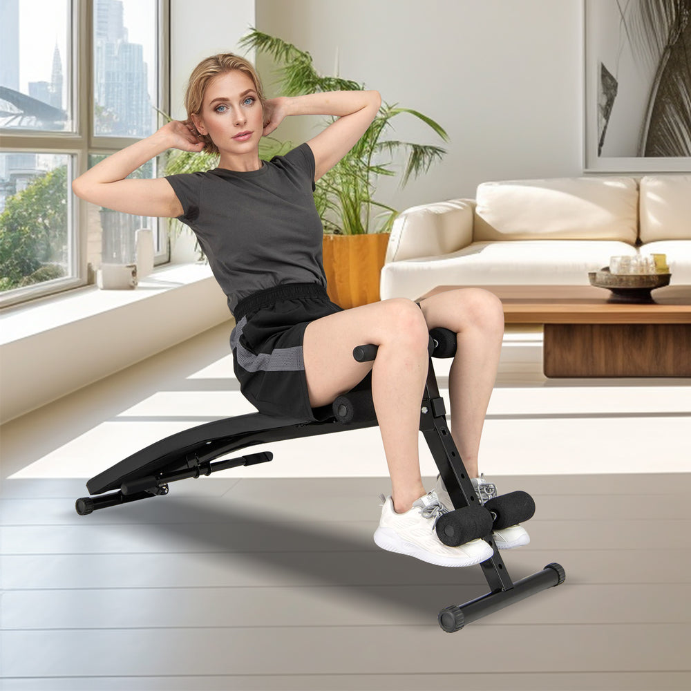 Adjustable decline sit-up bench with padded cushion, suitable for various exercises, shown in a modern living space.