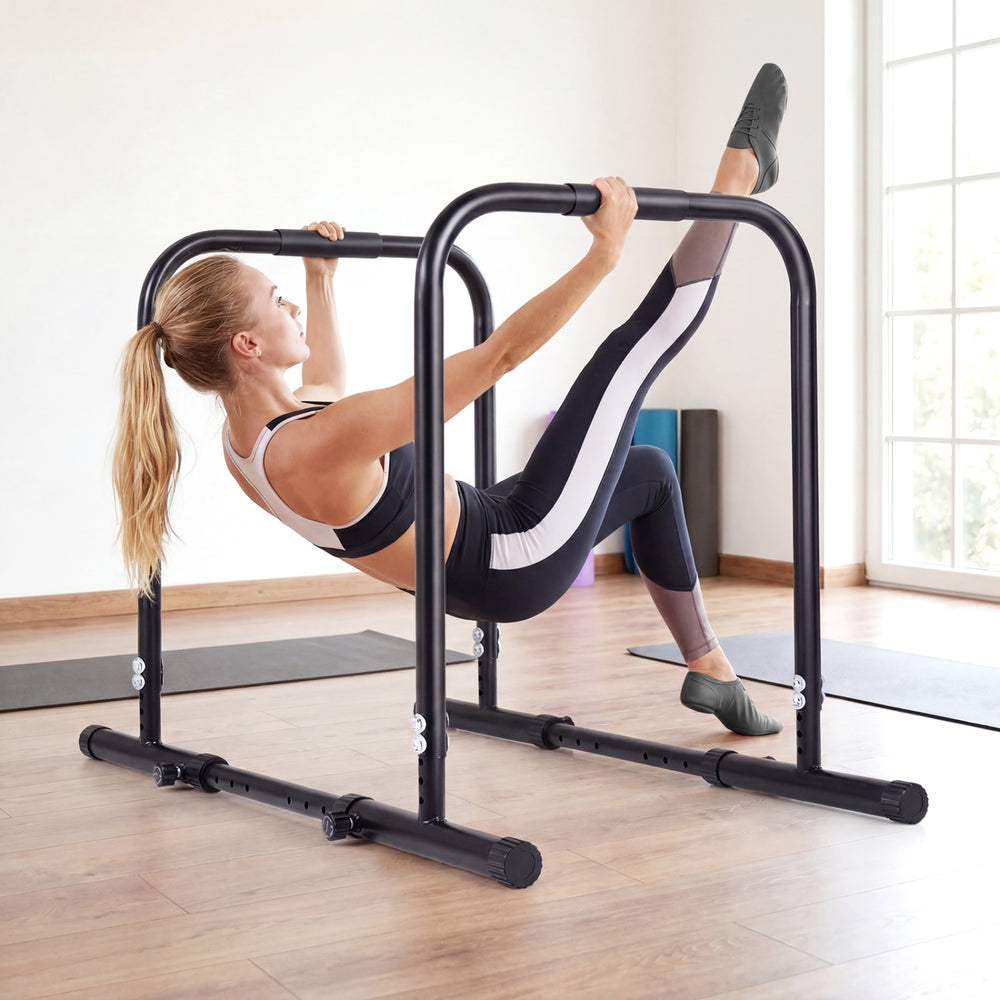 Adjustable dip bar station in black, featuring a heavy-duty frame and foam-padded handles for versatile home workouts.