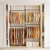 Adjustable black floor-to-ceiling clothes rack with four hanging rods, perfect for organizing T-shirts and jackets.