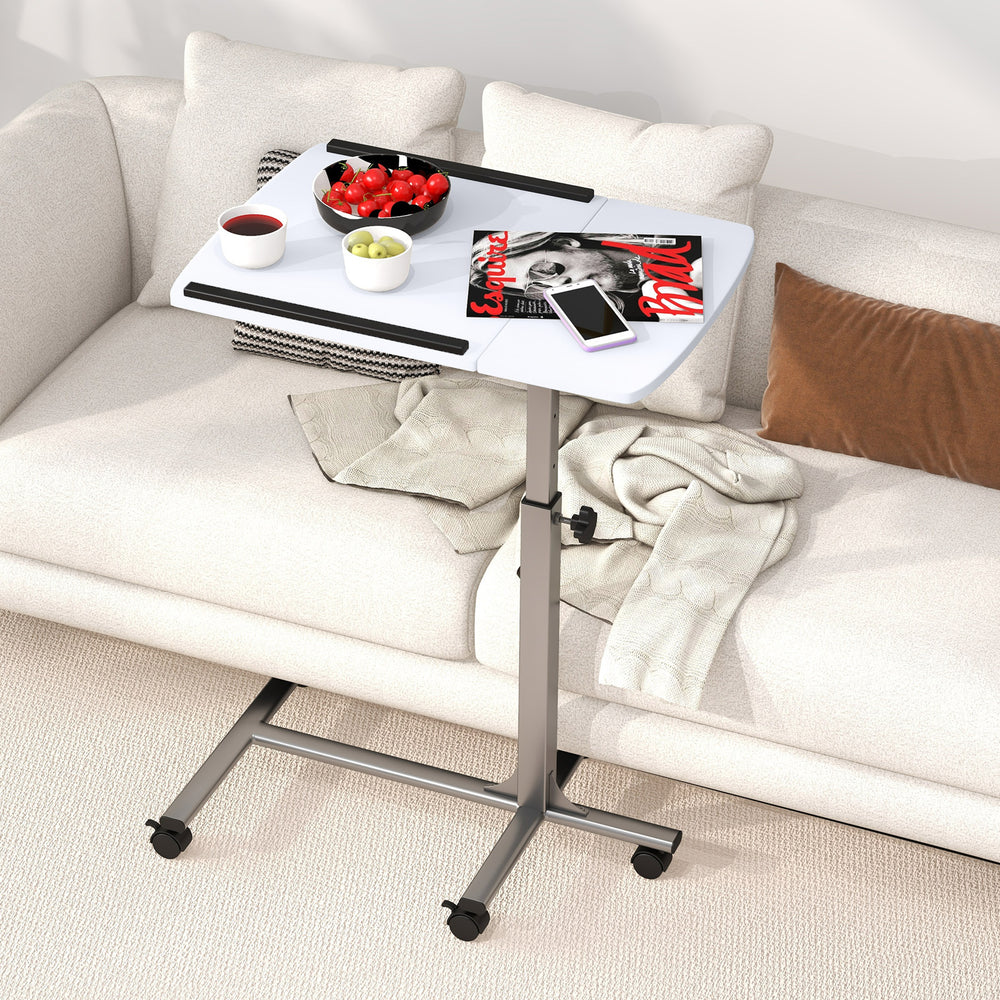 Adjustable height rolling laptop table in white with a sturdy steel frame, perfect for versatile use on a sofa.