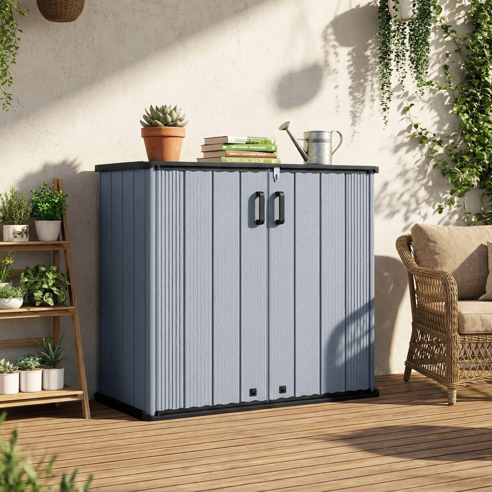 Gray all-weather storage box with lockable doors and removable shelf, ideal for organizing patio tools and equipment.