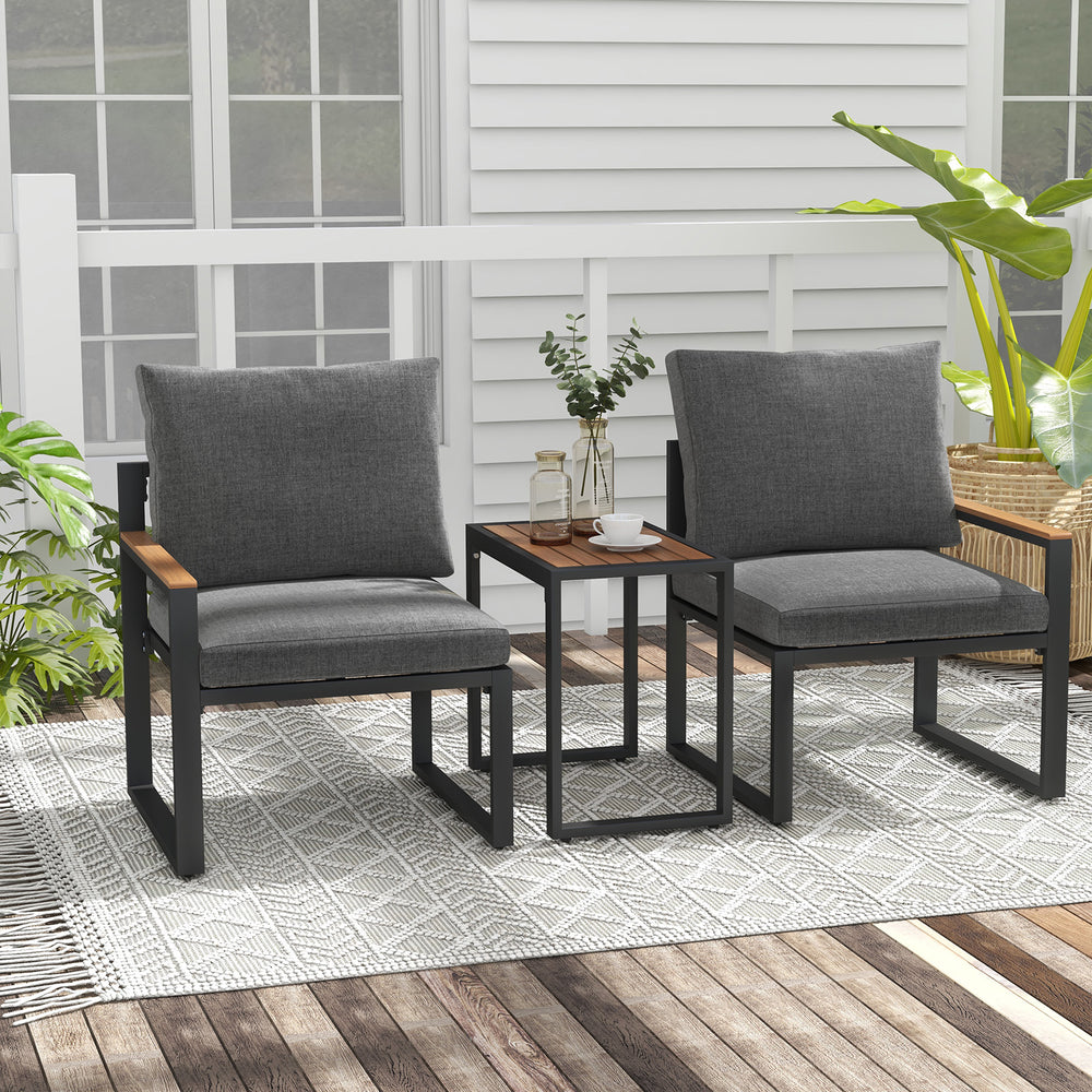 Two gray cushioned chairs with a small table, featuring aluminum frames, on a patio rug for outdoor conversation.