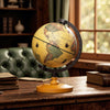 Antique 5.5-inch globe on an elegant wooden base, showcasing geographic details and effortless rotation for easy.