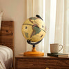 Mini rotating antique globe with a wooden base, featuring clear geographic details for educational and decorative use.