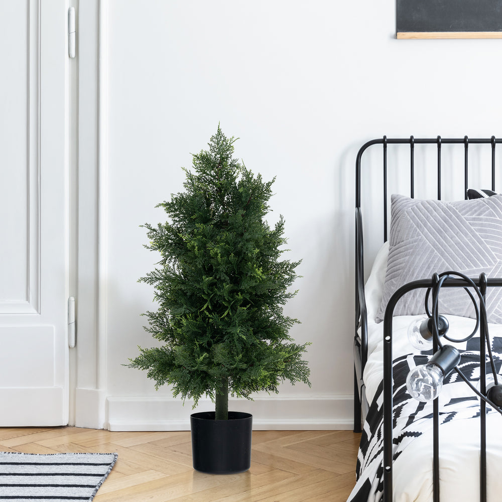 Artificial cedar topiary tree in a plastic nursery pot, perfect for office or porch decor with realistic leaves.