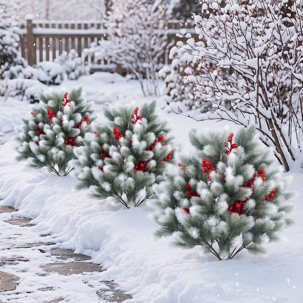 Artificial cedar topiary ball trees with red berries and snow-covered foliage, ideal for winter outdoor decoration.