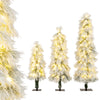 Close-up view of snow-flocked branch tips on a tall artificial Christmas tree, featuring warm white LED lights for a.
