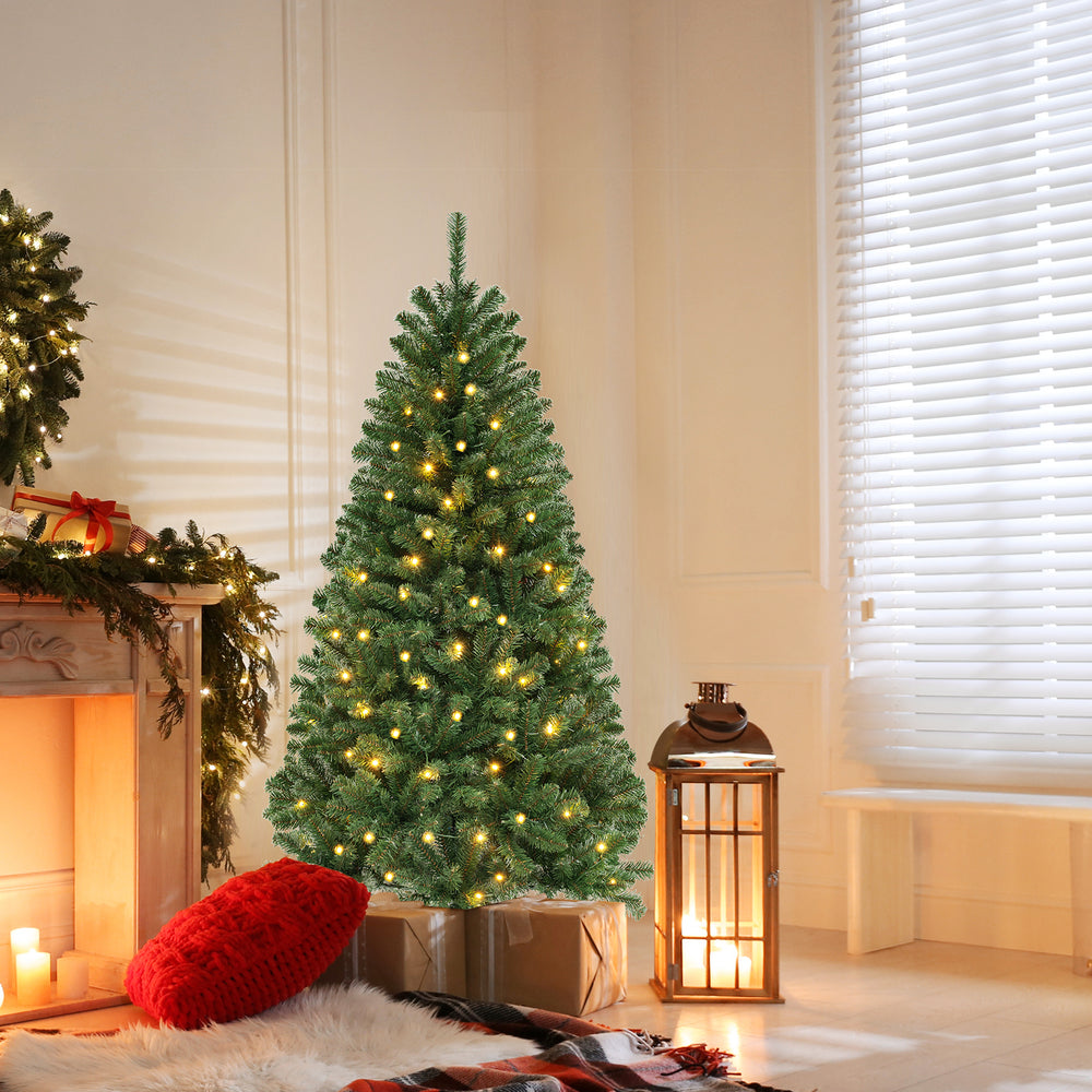 Artificial Christmas tree with warm white LED lights, featuring dense branch tips, perfect for holiday home decoration.