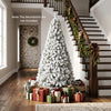Snow-flocked 6 ft artificial Christmas tree with 1498 branch tips, perfect for indoor holiday decoration.