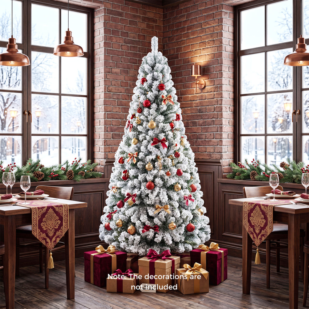 Snow-flocked 6 ft artificial Christmas tree with lush branch tips, perfect for indoor holiday decoration or parties.