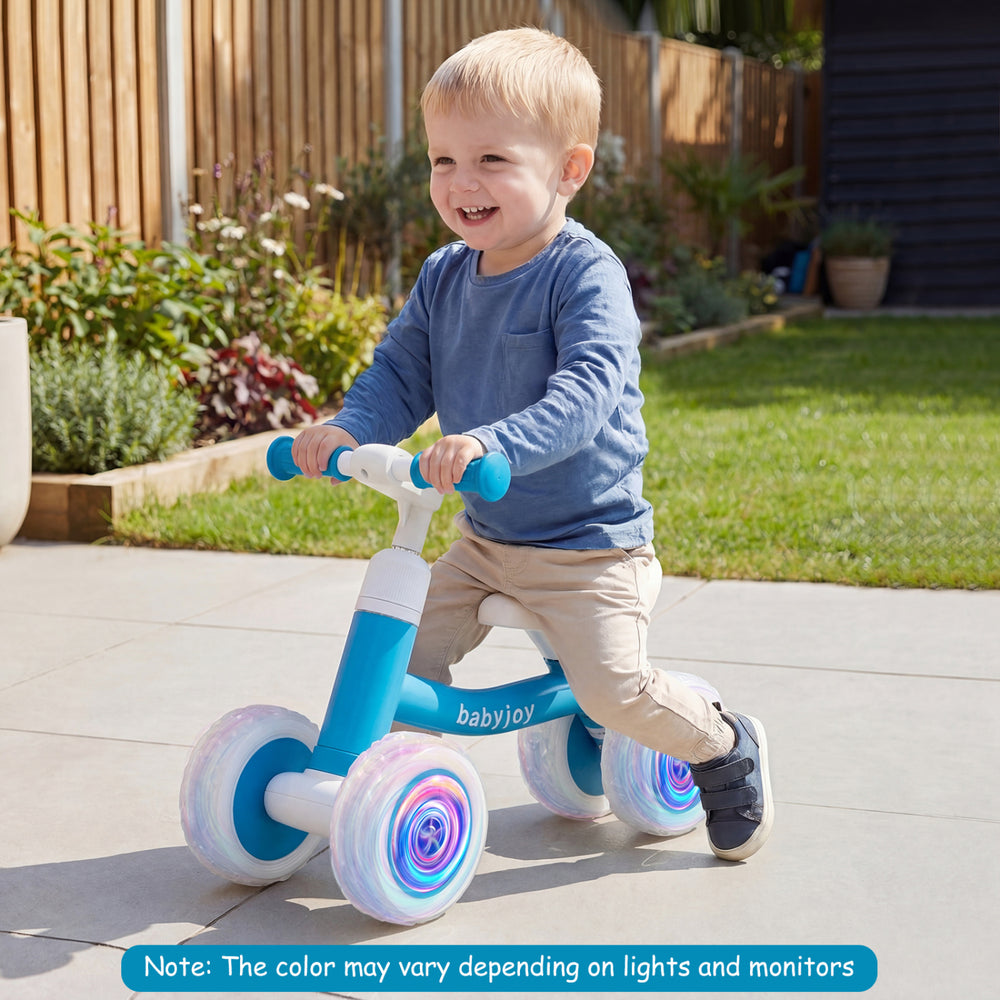 Blue baby balance bike with adjustable handlebars and glowing wheels, designed for indoor and outdoor fun.
