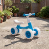 Baby balance bike in blue with adjustable seat and handlebars, featuring glowing wheels for fun indoor and outdoor.