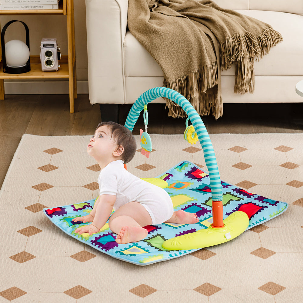 Baby playing on a colorful 4-in-1 activity center mat with adjustable height and interactive toys for developmental fun.