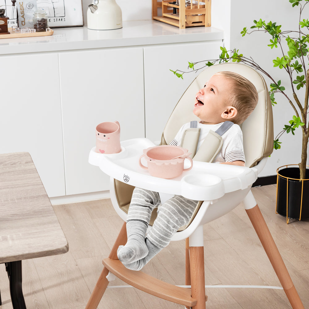 Beige baby high chair with non-slip foot pads, adjustable tray, and 5-point harness, providing stability and comfort.