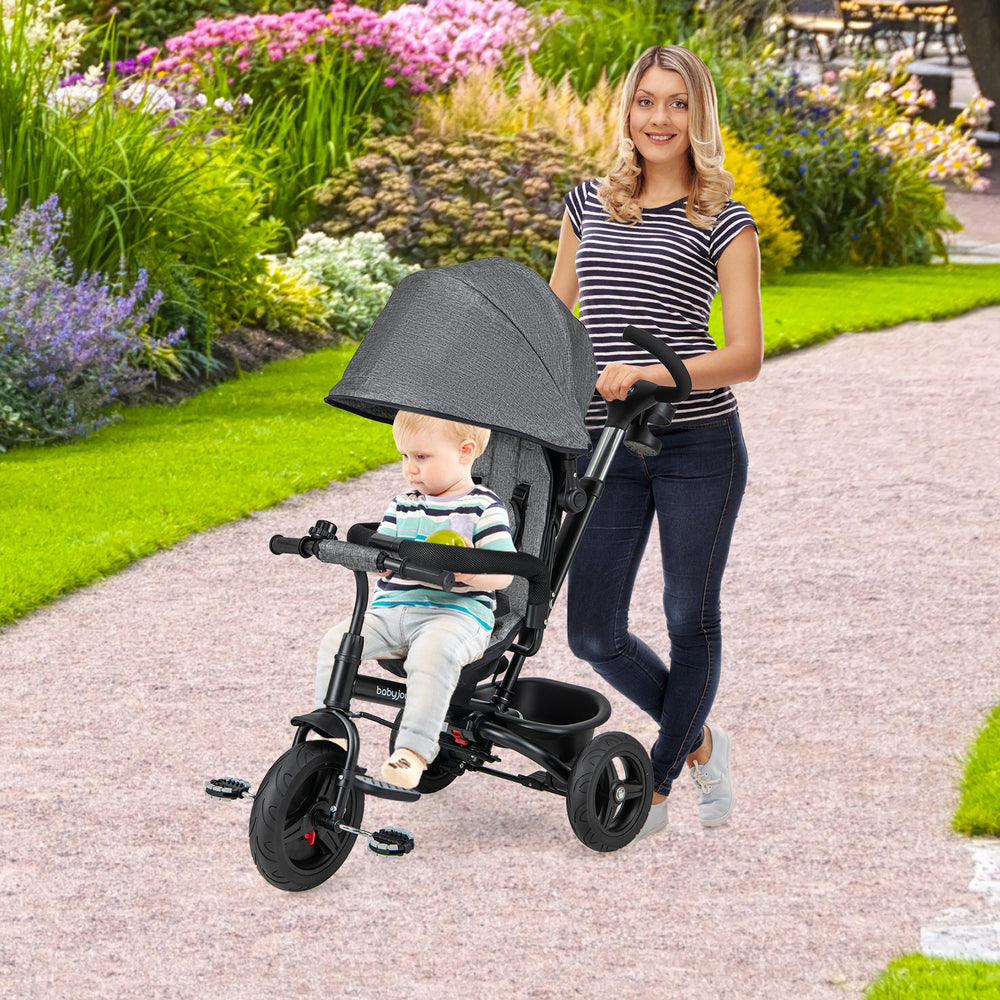 4-in-1 gray baby tricycle with reversible seat, adjustable canopy, and 5-point safety harness for outdoor fun.