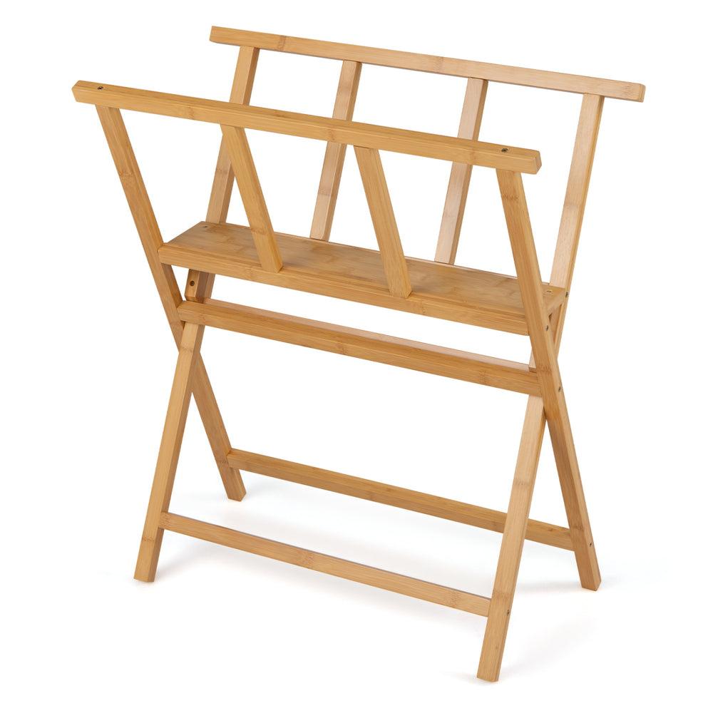 Bamboo art print rack with open storage design, X-shaped support legs, and middle shelf for displaying artworks and photos.
