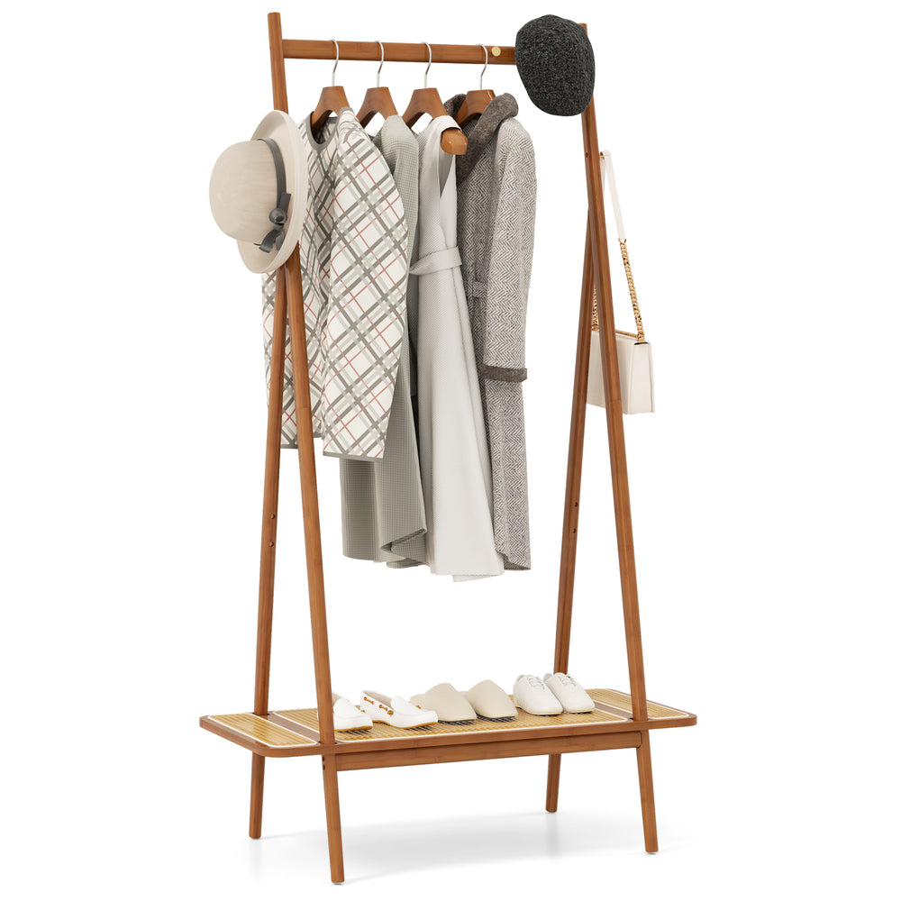 Bamboo clothes rack with hanging rod, rattan shelf, and copper hooks, ideal for organizing coats and accessories.