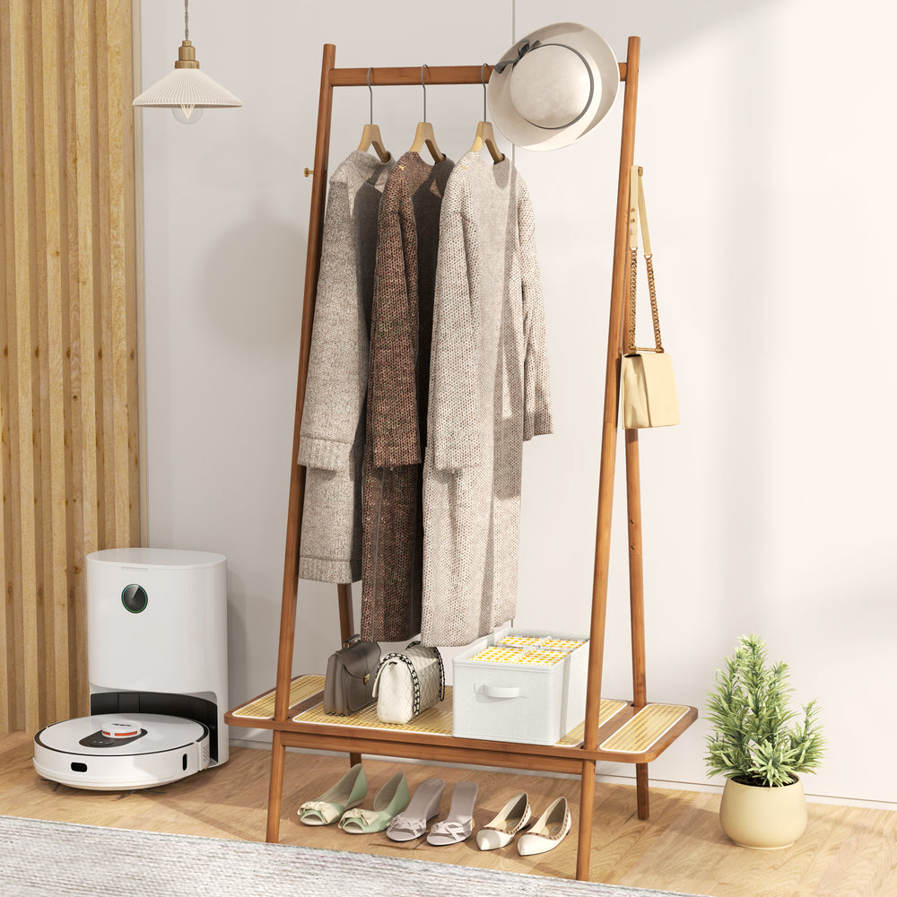 Bamboo clothes rack with hanging rod, rattan shelf, and copper hooks, perfect for organizing coats and accessories.