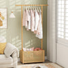 Bamboo clothes rack with hanging rod and rattan storage basket on wheels, perfect for entryway or living room.