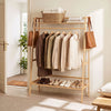 Bamboo clothing garment rack with hanging rod, two shelves, and side hooks, perfect for organizing your entryway or bedroom.