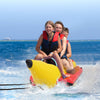 Three kids enjoying a ride on a bright yellow inflatable banana boat, designed for durability and safety on water.