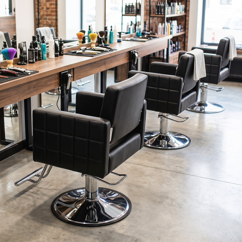 Black barber salon chair with hydraulic pump, adjustable height, and 360° swivel for comfortable styling sessions.