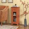 Freestanding brown storage cabinet with glass door, drawer, and adjustable shelf for versatile organization in any room.