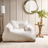Plush beige bean bag chair with ergonomic support, ideal for relaxing, reading, or watching TV in any room.