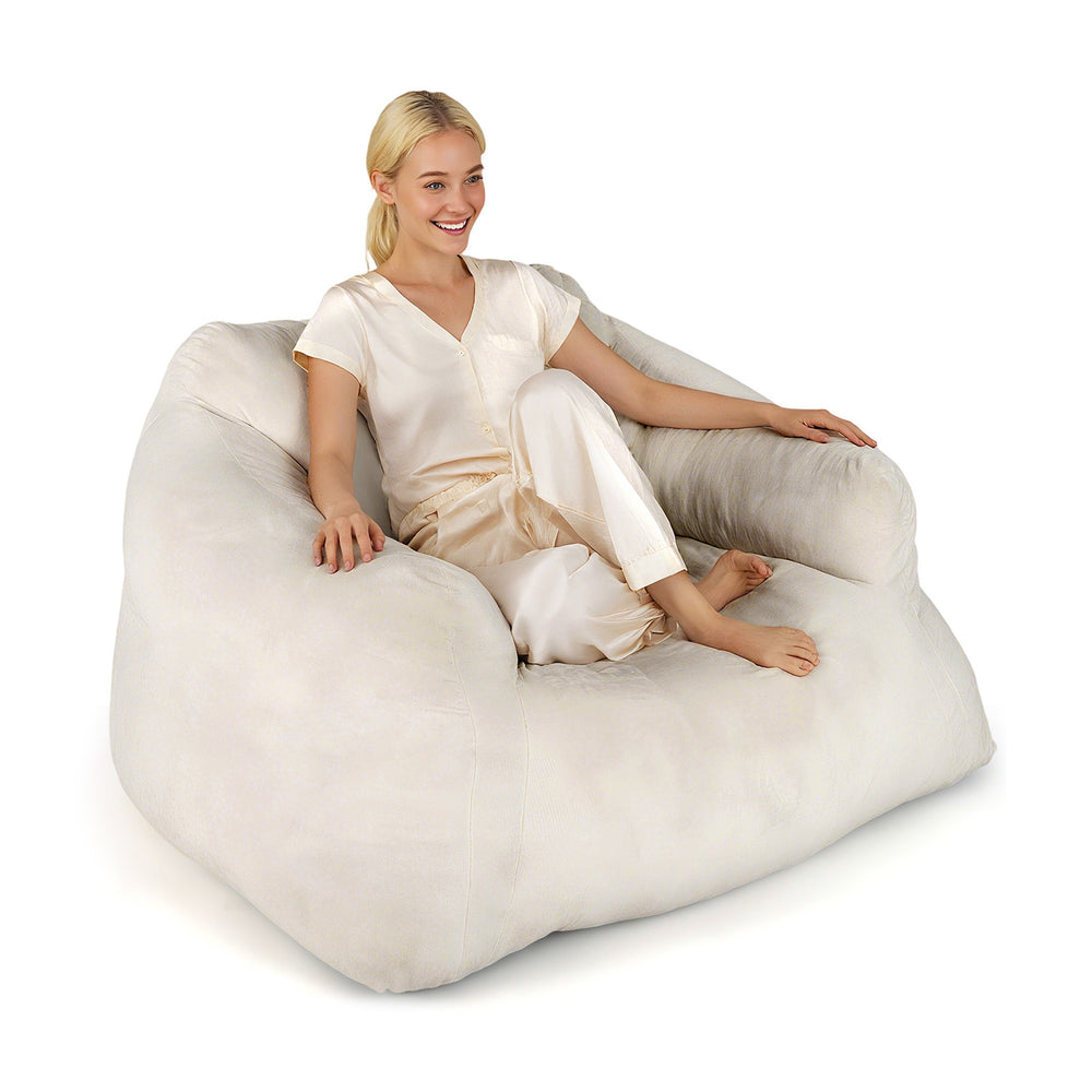 Plush beige bean bag chair with ergonomic support, ideal for relaxing, reading, or watching TV.