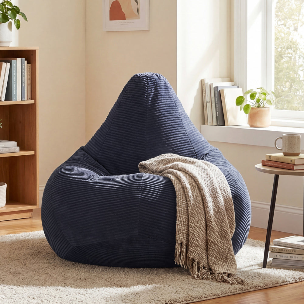 Blue bean bag chair with corduroy cover and soft sponge filling, perfect for relaxing in living rooms or bedrooms.
