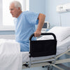 Height adjustable bed assist rail with padded handrail, providing support for elderly adults getting in and out of bed.