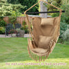 Beige hanging rope swing chair with soft pillow and cushions, featuring elegant tassels, perfect for outdoor relaxation.