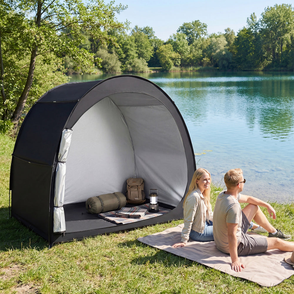 Portable bike storage tent made of waterproof PU coated oxford fabric, set up by a lake for outdoor convenience.