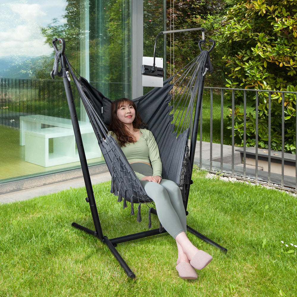 Height adjustable gray hammock chair with phone holder, side pocket, and cozy cotton material for outdoor relaxation.