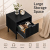 Black modern nightstand featuring a vertical-striped storage drawer and open shelf, perfect for compact bedside organization.