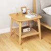 Boho bamboo side table with faux rattan shelf, featuring a natural finish and elegant curved design for versatile.
