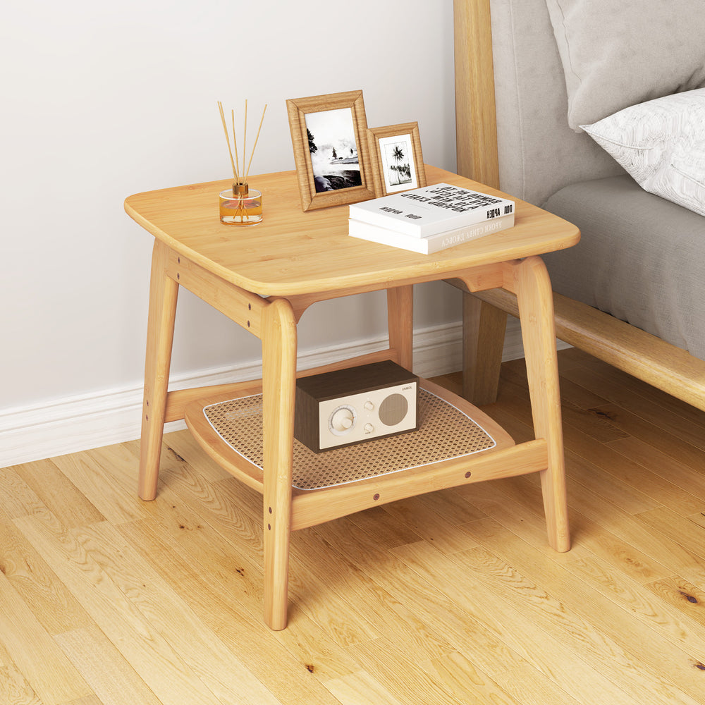 Boho bamboo side table with faux rattan shelf, featuring a natural finish and elegant curved design for versatile.