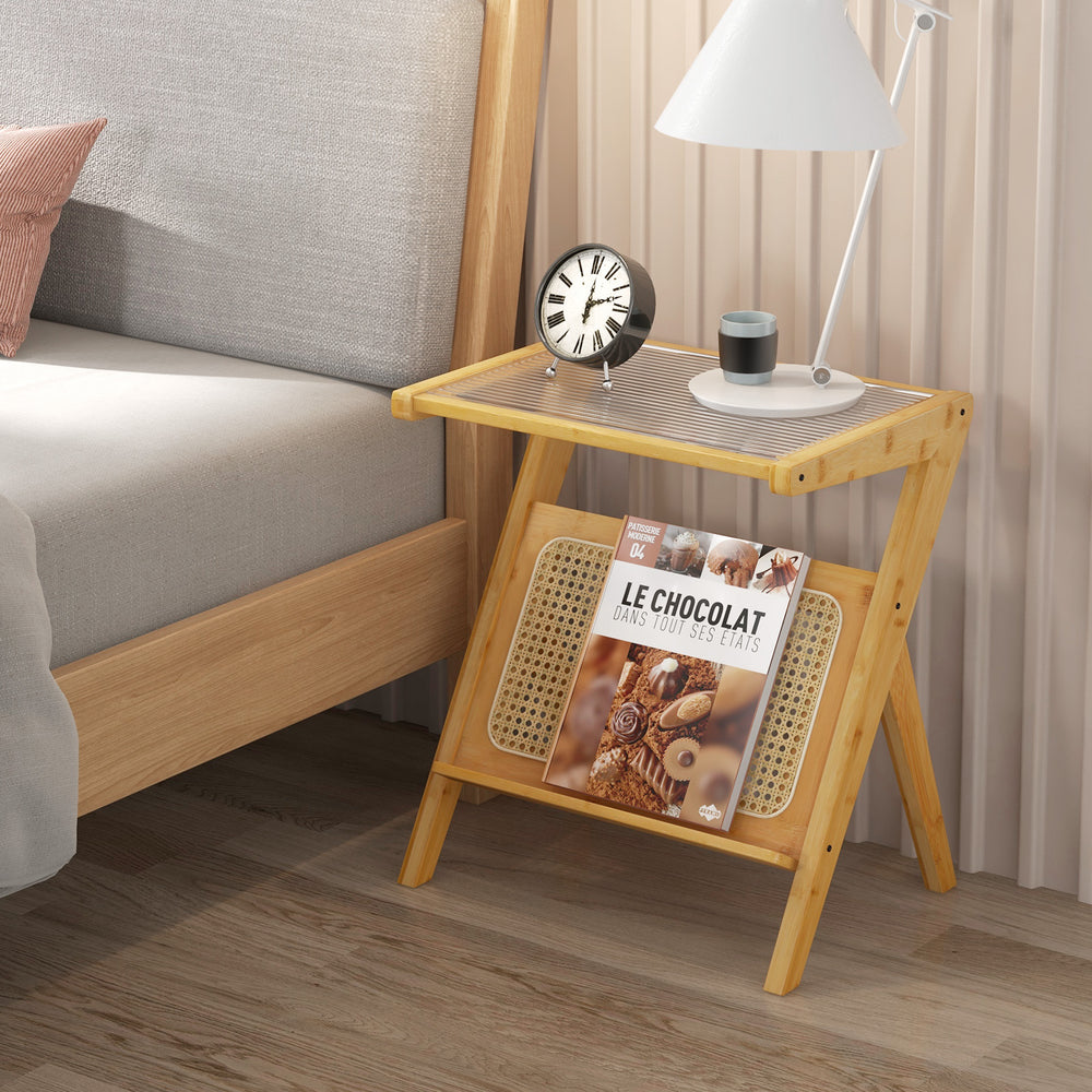 Boho end table with tempered glass top and rattan magazine rack, perfect for bedside or living room use.